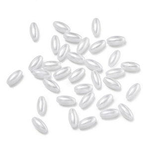 Macro detail of oval ABS faux pearl beads with high-gloss finish for DIY jewelry making