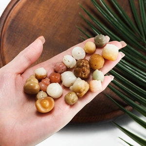 Handcarved Bodhi root beads in traditional shapes like Buddha and lotus for DIY jewelry