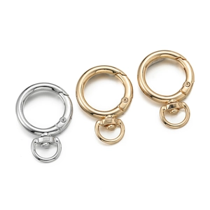Three swivel spring ring snap hooks in gold and silver finish on white background