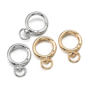 Detail of gold and silver zinc alloy round spring o-rings with 360-degree swivel clasps