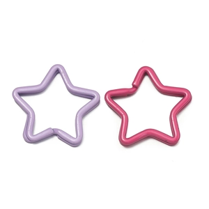 Close-up of lavender and rose red star-shaped metal keyrings for DIY bag accessories
