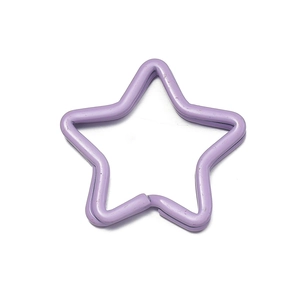 Macro detail of purple star-shaped metal keyring with smooth lacquer finish for DIY crafts