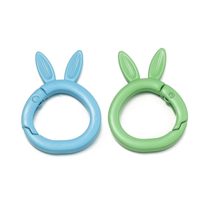 Detail of blue and green matte rabbit-shaped alloy spring buckles for DIY keychains