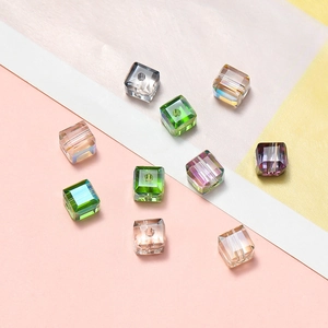 Macro shot of 6mm faceted crystal glass cubes with AB coating on a colorful background