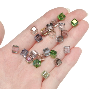 Close-up of 6mm faceted crystal cube beads held in hand for DIY jewelry making