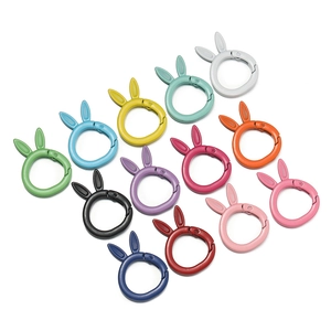 Detailed grid of twelve colorful bunny-ear spring ring clasps in matte finish