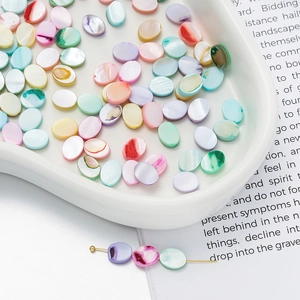 Macro shot of colorful oval shell beads with natural luster for DIY jewelry making