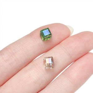 Macro detail of 6mm cube faceted glass beads with AB colorful iridescent coating
