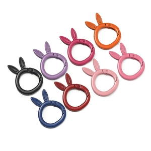 Detailed view of rabbit-ear spring buckles in 8 matte colors on a white background