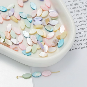 Macro detail of colorful marquise mother of pearl shell beads with iridescent gloss