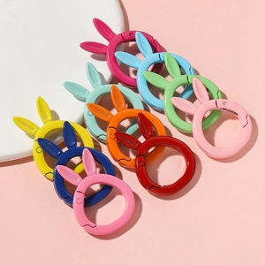 Detailed view of colorful rabbit ear spring ring clasps in various matte finishes