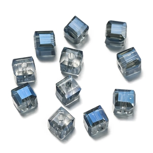 Macro detail of 6mm faceted blue glass cube beads with precision drilled holes