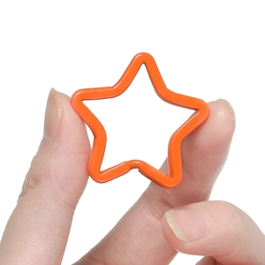 Close-up of orange star-shaped metal lobster clasp for DIY bag and keychain accessories
