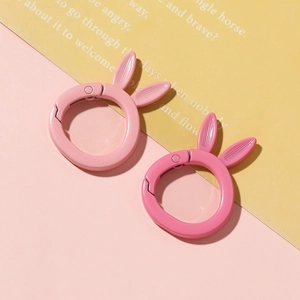 Macro view of rabbit-eared alloy spring ring clasps in light and dark pink matte finish