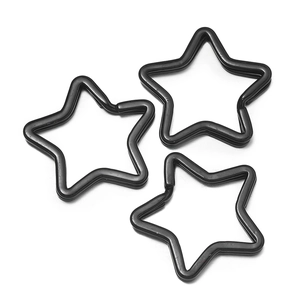 Close-up of three star-shaped black metal split rings for DIY keychain accessories
