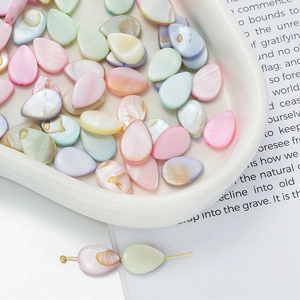 Macro view of teardrop mother of pearl beads in macaroon colors for DIY jewelry