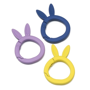 Macro view of colorful matte rabbit ear spring rings for DIY keychains and bag charms