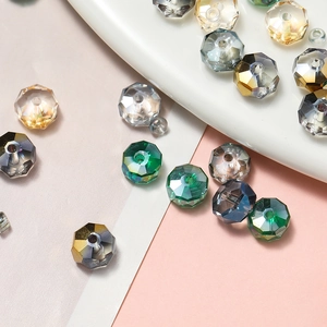Macro shot of colorful faceted glass wheel beads on a ceramic tray for DIY jewelry