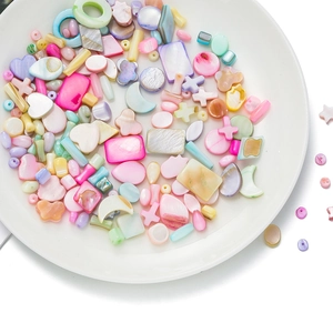 Macro detail of colorful heart and star shell beads for DIY jewelry making sets