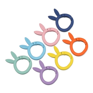 Detailed view of colorful rabbit ear shape spring ring alloy buckles in seven matte finishes