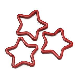 Close-up of three red star-shaped metal split rings for DIY keychain accessories