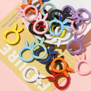 Close-up of colorful matte bunny-shaped spring ring buckles for DIY crafts and keychains