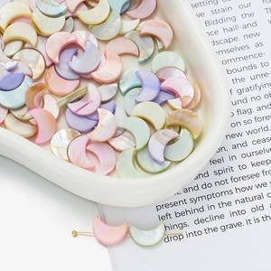 Macro view of colorful moon-shaped shell beads for DIY jewelry making and crafts