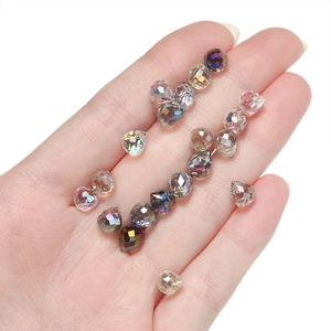 Faceted AB crystal glass teardrop beads for DIY jewelry making held in hand
