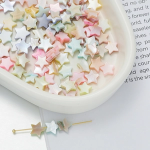 Macro detail of macaron colored star beads with iridescent pearl luster for DIY jewelry
