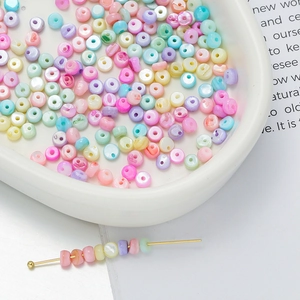 Macro shot of colorful macaron-toned shell beads in a heart tray for DIY jewelry projects