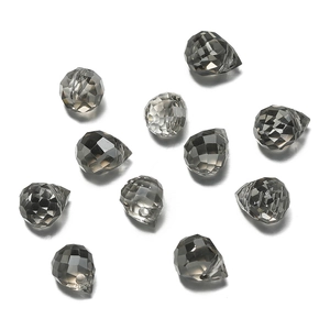 Macro detail of faceted grey glass teardrop beads for jewelry making with clear textures