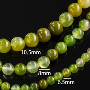 Macro view of green agate beads in 10.5mm, 8mm, and 6.5mm sizes for DIY jewelry