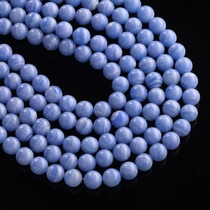 Detailed view of blue lace agate beads with white striped patterns on black mirror base