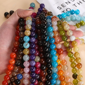 Macro detail of polished dragon vein agate beads showing natural textures and colors