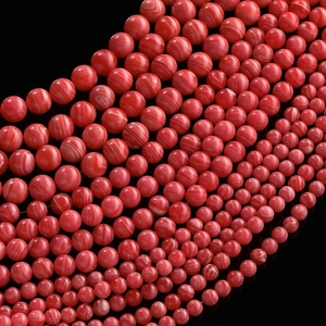 Detailed view of polished red striped agate beads for DIY jewelry making and crafts