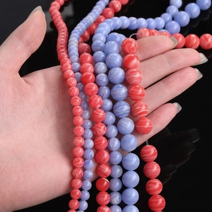 Polished synthetic onyx beads with striped patterns in red and blue for DIY jewelry