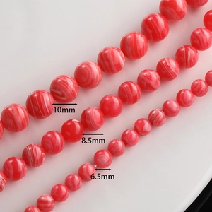 Detailed view of red silk-striped agate beads in 10mm, 8.5mm, and 6.5mm sizes