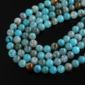 Macro shot of blue-green dragon vein agate beads with unique natural crackle texture