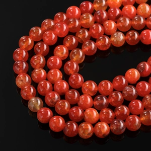 Macro view of polished red dragon vein agate beads showing natural internal ice cracks