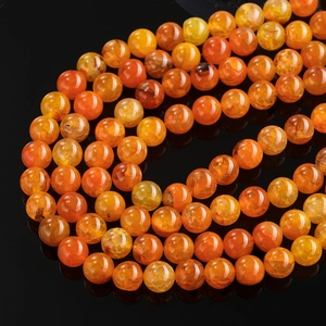 Macro shot of orange dragon vein agate beads with natural ice crack texture and glossy finish