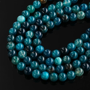 Macro shot of polished dragon vein agate beads with unique blue crackle pattern