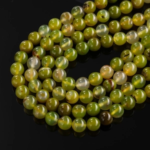 Macro shot of high-quality green agate beads with polished texture and ice-crack pattern