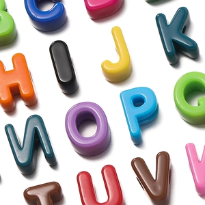 Macro shot of 3D colorful acrylic alphabet beads with smooth glossy finish for DIY jewelry