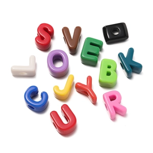Macro shot of colorful acrylic large-hole alphabet beads for DIY jewelry making
