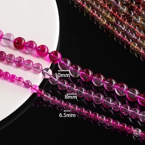 Close-up of 10mm, 8mm, and 6.5mm colorful phantom crystal glass beads for DIY jewelry