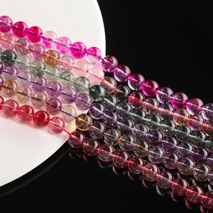 Macro view of colorful translucent crystal beads with polished finish on white porcelain plate