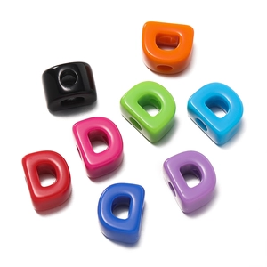 Macro shot of colorful acrylic letter D beads with large holes for DIY jewelry