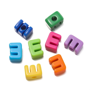 Macro view of colorful acrylic alphabet beads with large holes for DIY jewelry