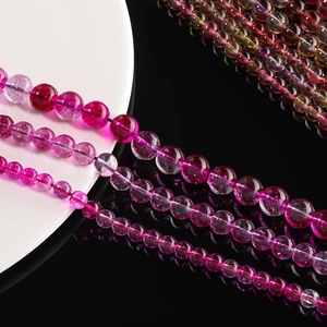 Macro shot of colorful ghost crystal beads featuring natural textures and vibrant pink tones