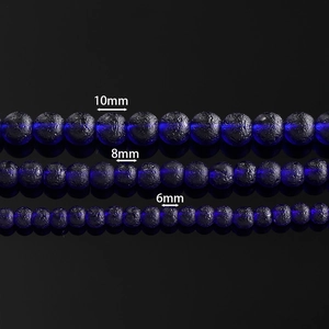 Macro detail of 6mm to 10mm textured blue glass beads for DIY jewelry making